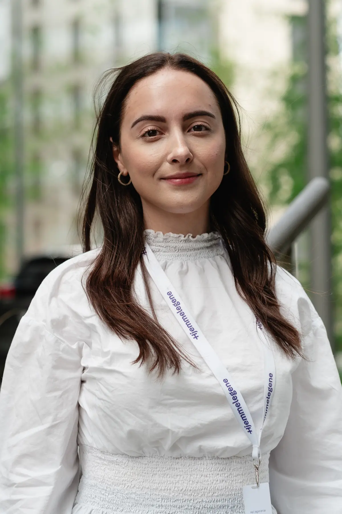 Woman wearing white posing for company portrait