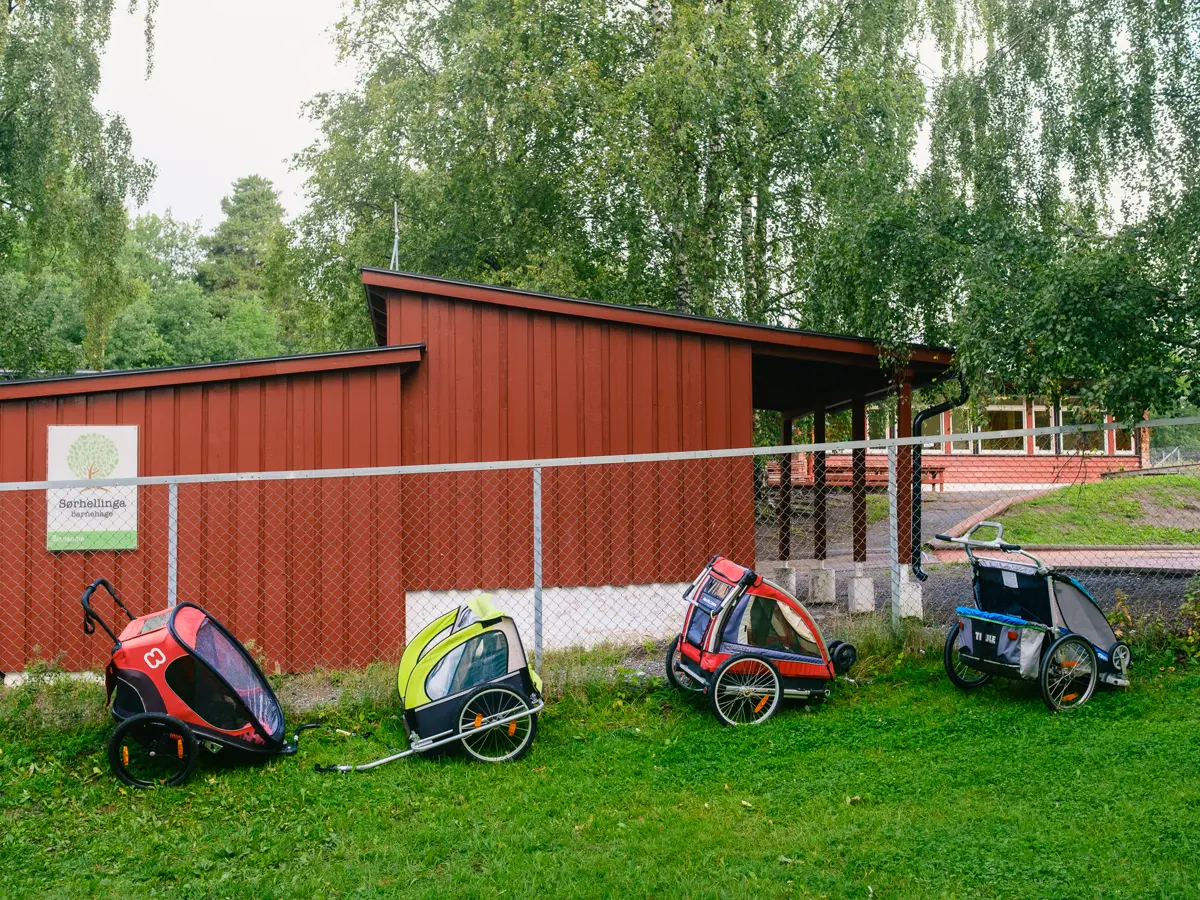 Bike trailers parked outside kindergarden.