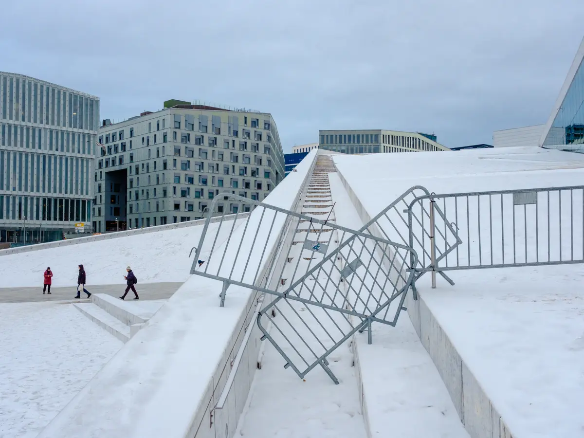Temporary fencing stacked untidily across the walkway to the roof of Oslo Opera House where the prime feature of it's architecture is the ability for the public to walk on the roof.