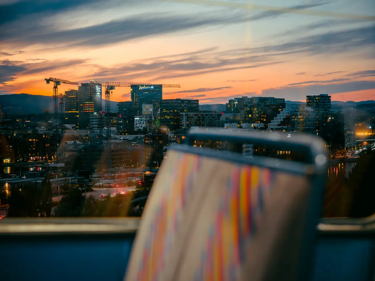 Oslo seen from the tram window at sunset with tram car interior in the foreground.