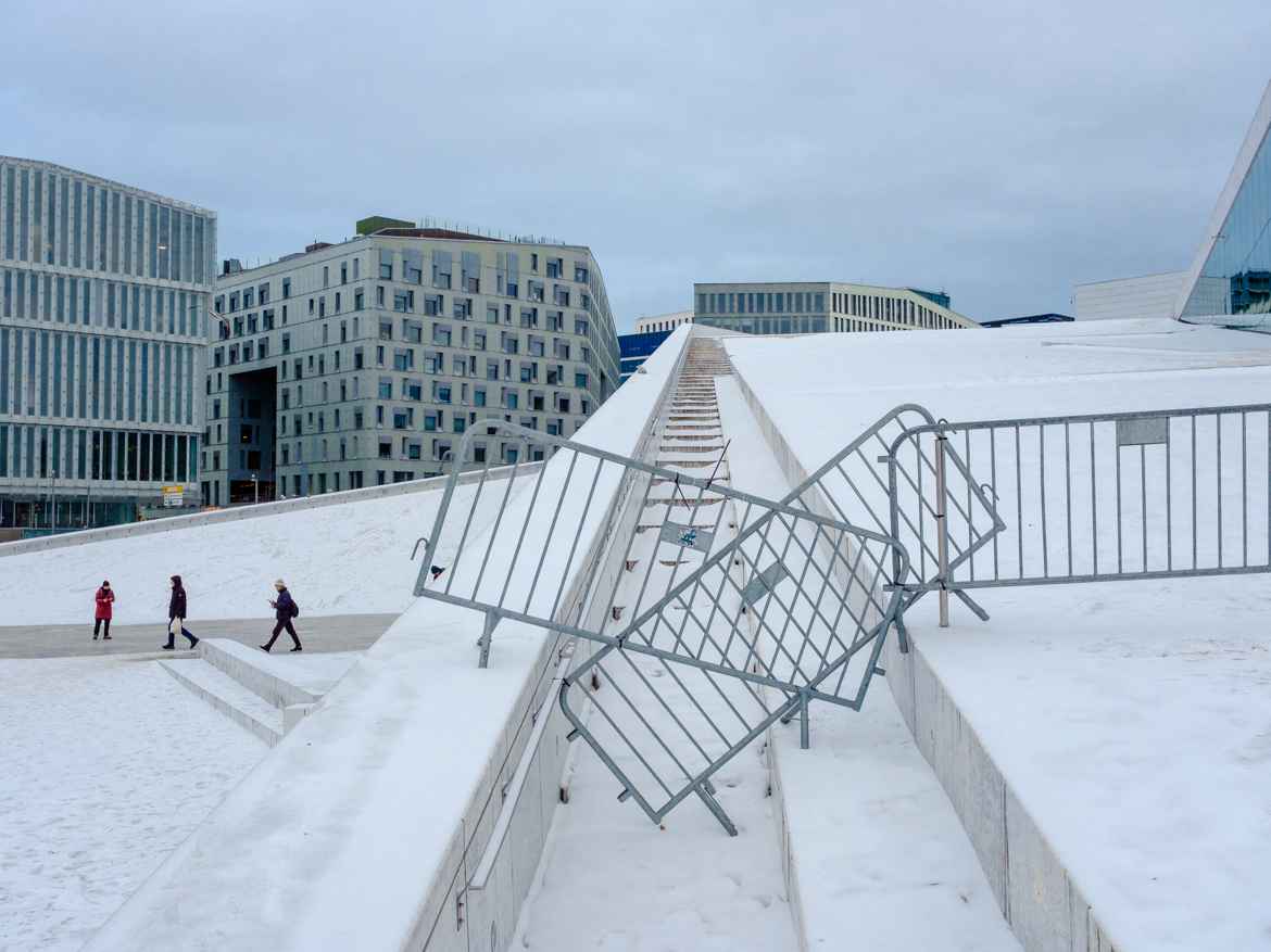 Temporary fencing stacked untidily across the walkway to the roof of Oslo Opera House where the prime feature of it's architecture is the ability for the public to walk on the roof.