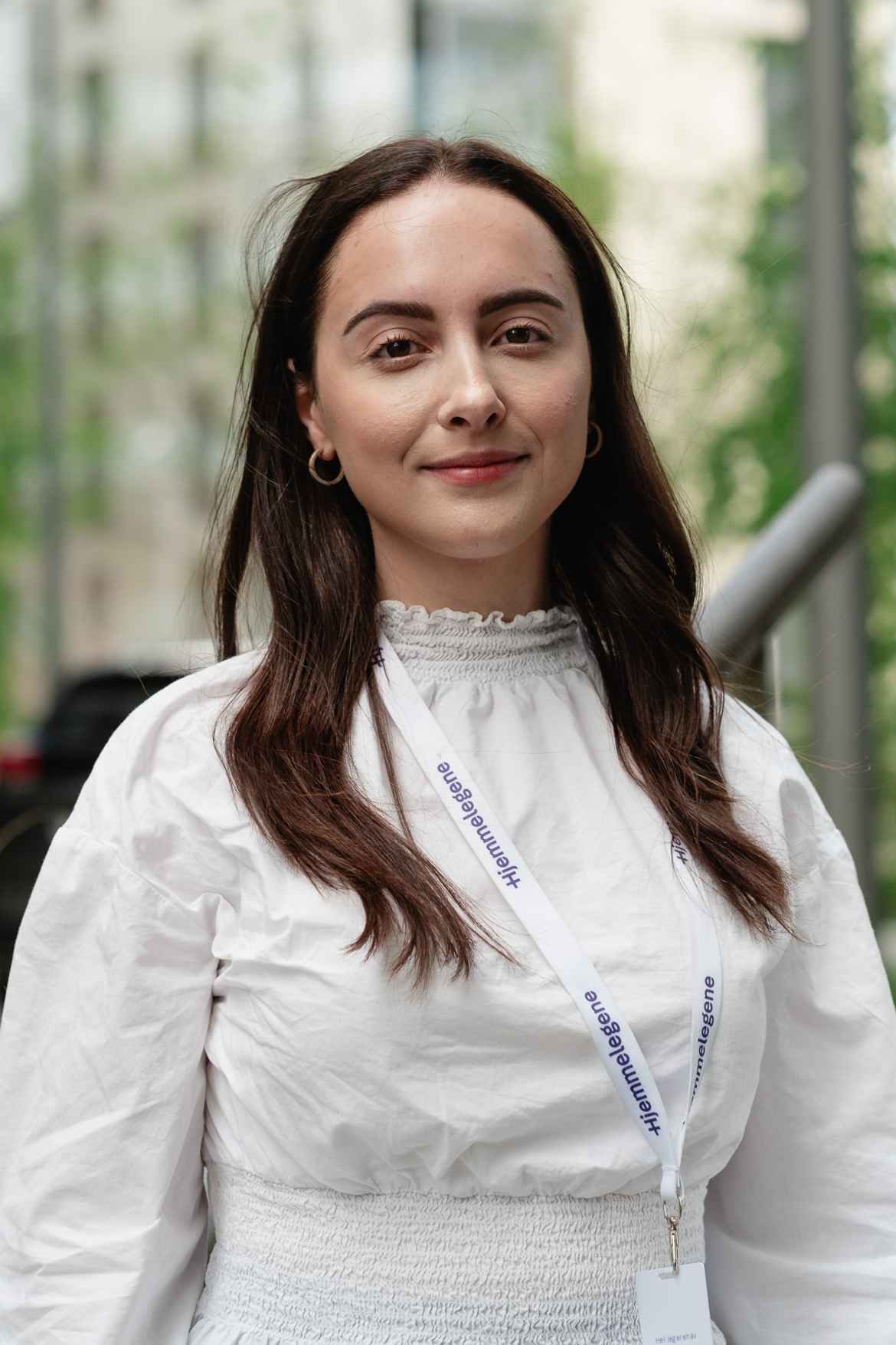 Woman wearing white posing for company portrait