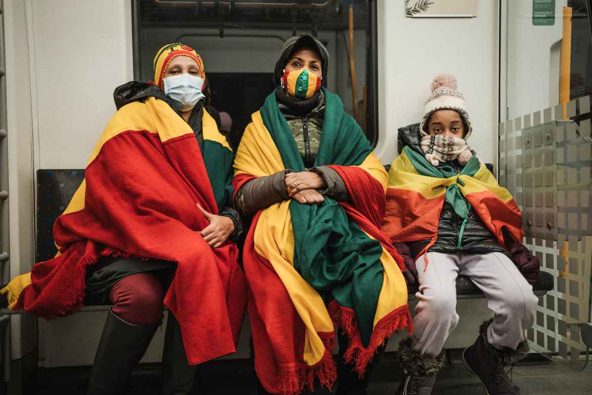 Ethiopian women and boy on the subway heading into Oslo to show support for Ethiopian Prime Minister Abiy Ahmed. Their slogan "no more" refers to the pressure on Mr Abiy by western media who has been heavily criticized for poorly handling the conflict with the Northern Tigray province.
